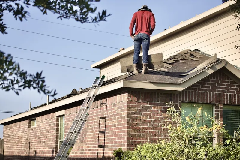 Professional roofer working on a residential roof in Wayfare Estates